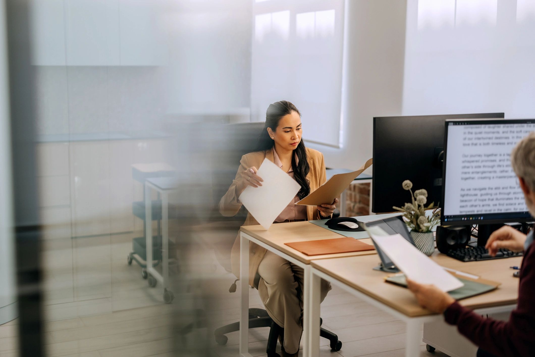 Professional reviewing paperwork at a desk